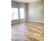 A large room with great natural light and laminate wood flooring at 3207 Geary Trl, Raleigh, NC 27610