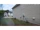 Side yard of the house with AC, electrical outlets, and view into the neighborhood at 3207 Geary Trl, Raleigh, NC 27610