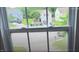 A view from a window showcasing a quiet, residential neighborhood with colorful homes and well-maintained lawns at 3207 Geary Trl, Raleigh, NC 27610