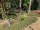 Secluded backyard with mature trees, colorful azaleas, and stone pathway at 36A Country Club Dr, Rocky Mount, NC 27804