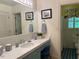 Charming bathroom with blue vanity, framed art, and patterned tiles at 36A Country Club Dr, Rocky Mount, NC 27804