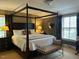 Well-lit bedroom features a four-poster bed with bedside lamps and windows at 36A Country Club Dr, Rocky Mount, NC 27804
