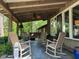 Relaxing covered porch with rocking chairs, offering a serene outdoor retreat with great natural views at 36A Country Club Dr, Rocky Mount, NC 27804