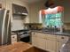 Well-lit kitchen featuring stainless steel appliances, granite countertops, and neutral-toned cabinets at 36A Country Club Dr, Rocky Mount, NC 27804