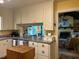 Bright kitchen featuring a breakfast bar pass-through, granite countertops, and ample cabinet space at 36A Country Club Dr, Rocky Mount, NC 27804