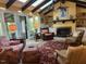 Spacious sunroom featuring high ceilings, a brick fireplace, and french doors leading to outdoor living at 36A Country Club Dr, Rocky Mount, NC 27804