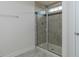 Modern bathroom shower featuring tiled walls, glass doors, and a convenient shower caddy at 417 Hipwood Dr, Zebulon, NC 27597