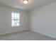 Comfortable bedroom with a view and carpeted floors, awaiting your personal touch at 417 Hipwood Dr, Zebulon, NC 27597