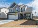 Charming two-story home with a well-maintained lawn, stone accents, and a two-car garage at 417 Hipwood Dr, Zebulon, NC 27597