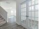 Bright foyer featuring wood-look flooring, staircase and glass paneled doors leading to another room at 417 Hipwood Dr, Zebulon, NC 27597