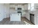Contemporary kitchen with white cabinets, stainless steel appliances, and a kitchen island at 417 Hipwood Dr, Zebulon, NC 27597