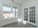 Inviting living room featuring glass paneled doors, neutral walls, and bright windows at 417 Hipwood Dr, Zebulon, NC 27597