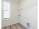 Bright closet features wood-look flooring, wire shelving, and a window for natural light at 425 Hipwood Dr, Zebulon, NC 27597