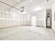 Unfinished garage space with a concrete floor, water heater, and ample room at 425 Hipwood Dr, Zebulon, NC 27597