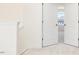 Upstairs hallway with carpet flooring, base molding and doors to bedrooms at 425 Hipwood Dr, Zebulon, NC 27597