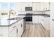 Modern kitchen showcasing stainless steel appliances, granite countertops and white cabinetry at 425 Hipwood Dr, Zebulon, NC 27597