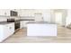 Modern kitchen featuring a granite island, stainless steel appliances, and white cabinets at 425 Hipwood Dr, Zebulon, NC 27597