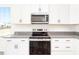 Modern kitchen with stainless steel appliances, granite countertops, and ample cabinet space at 425 Hipwood Dr, Zebulon, NC 27597