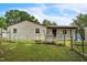 Back exterior of home with a small fenced-in area and grassy yard at 428 Walton St, Durham, NC 27703