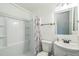Bathroom featuring a shower/tub combo with white shower curtain, white toilet and white vanity sink at 428 Walton St, Durham, NC 27703