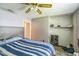 Bedroom showcasing a bed, ceiling fan and an open closet space with a rod for hanging clothing at 428 Walton St, Durham, NC 27703