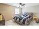 This bedroom features a ceiling fan, a window with blinds, and a bed with storage drawers at 428 Walton St, Durham, NC 27703