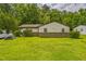 Charming single-story home features a well-maintained lawn and a classic brick foundation at 428 Walton St, Durham, NC 27703