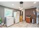 A bright kitchen with a brick accent wall, appliances, and easy access to the laundry at 428 Walton St, Durham, NC 27703