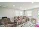 Cozy living room with reclining furniture and a glass table at 428 Walton St, Durham, NC 27703