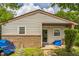 View of the side of a single story home showcasing the brick foundation, siding, and an easy access rear entry at 428 Walton St, Durham, NC 27703