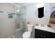 Modern bathroom with tiled shower, sleek vanity, and round mirror at 518 Buck Branch Dr, Garner, NC 27529
