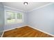 Bedroom with hardwood floors, light blue walls, and a window for natural light at 518 Buck Branch Dr, Garner, NC 27529