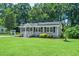 Charming home with gray siding, black shutters, solar panels and well-manicured lawn at 518 Buck Branch Dr, Garner, NC 27529