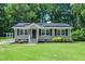 Charming home with gray siding, black shutters, solar panels and well-manicured lawn at 518 Buck Branch Dr, Garner, NC 27529