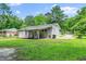 View of the home's rear exterior including a covered patio and lush yard at 518 Buck Branch Dr, Garner, NC 27529