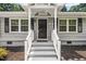 Close up of front porch with gray brick, black door, and white columns at 518 Buck Branch Dr, Garner, NC 27529
