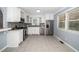 Bright kitchen with white cabinets, stainless steel appliances and gray backsplash at 518 Buck Branch Dr, Garner, NC 27529