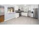Bright kitchen with white cabinets, stainless appliances, and gray backsplash at 518 Buck Branch Dr, Garner, NC 27529