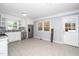 Open kitchen with white cabinets, stainless steel appliances, tile floor at 518 Buck Branch Dr, Garner, NC 27529