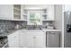 A close up of the stainless steel appliances and white cabinets in a bright, clean kitchen at 518 Buck Branch Dr, Garner, NC 27529