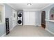 Laundry room with stacked washer and dryer, neutral walls, and tiled floor at 518 Buck Branch Dr, Garner, NC 27529