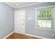 Room with hardwood floor, blue walls, white door and window at 518 Buck Branch Dr, Garner, NC 27529
