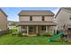 Charming backyard showcasing a covered patio, lush lawn, and playful slide at 542 Spaulding St, Burlington, NC 27215
