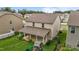 Aerial view of a backyard featuring a covered patio, lush lawn, and playful swing set area at 542 Spaulding St, Burlington, NC 27215