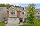 Charming two-story home featuring a brick and siding facade, attached garage and manicured landscaping at 542 Spaulding St, Burlington, NC 27215