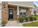 Inviting front porch with brick accents, decorative plants, and seating area near the front door at 542 Spaulding St, Burlington, NC 27215