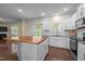 Open kitchen with white cabinets, stainless steel appliances, and wood countertop island at 542 Spaulding St, Burlington, NC 27215