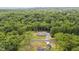 Overhead view of charming home surrounded by a lush forest, showcasing a serene and private setting at 5550 Mountain Trl, Snow Camp, NC 27349