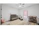 Cozy Bedroom with a crib, rocking chair, ceiling fan, and storage shelves in a bright room at 5550 Mountain Trl, Snow Camp, NC 27349