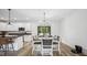 Elegant dining area featuring a chandelier, stylish chairs, and french doors to the backyard at 5550 Mountain Trl, Snow Camp, NC 27349
